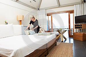 Hotel Chambermaid Making Guest Bed