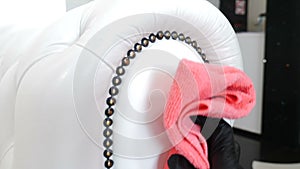 Hotel cleaning. Soft furniture surface and buttons being cleaned by female hands with wipe. Close-up view of woman