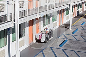 The hotel cleaning tool cart of housekeeper are on the walkway o