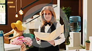 Hotel concierge reviewing bookings