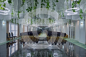 Hotel conference hall with empty chairs, green design with green plants and flowers