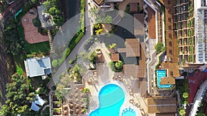 Hotel courtyard with palms and swimming pool. View from above