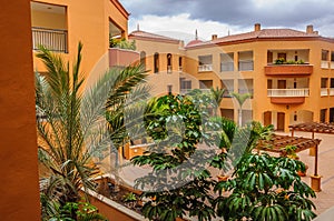Hotel courtyard with palms and trees in Tenerife, Spain