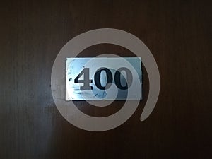 Hotel door number 400, close up image, wooden door.