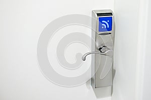 Hotel electronic lock on white door