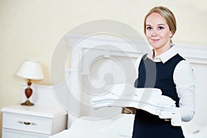 Hotel female housekeeping worker with linen