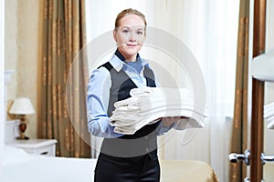 Hotel female housekeeping worker with linen