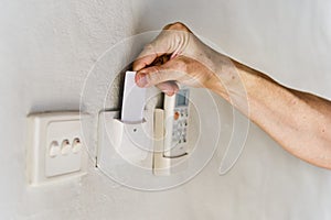 Hotel guest inserting keycard to turn the electricity on