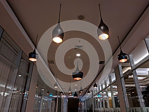 Hotel hallway reflection with glowing copper lamp