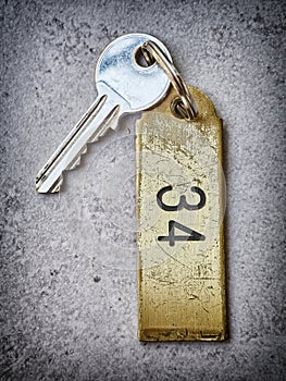 Hotel key with the key chain number 34.