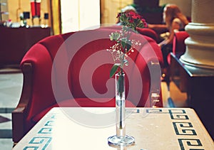 Hotel lobby lounge interior with red armchair and small table