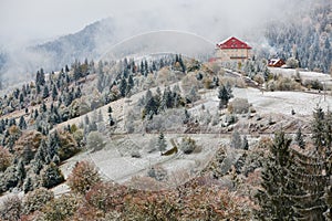 Hotel in mountains. Snow and fog.Winter coming