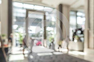 Hotel or office building lobby blur background interior view toward reception hall, modern luxury white room space