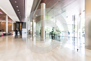 Hotel or office building lobby blur background interior view toward reception hall, modern luxury white room space