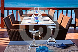 The hotel open air restaurant by the sea is waiting for guests.