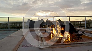 Hotel outdoor fireplace glows at pismo sunset