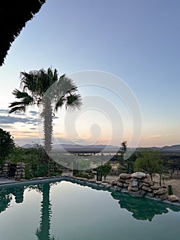 Hotel outdoors swimming pool in Africa. Sunset or sunrise.