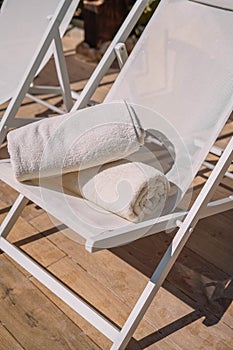 Hotel pool chair with folded towels photo