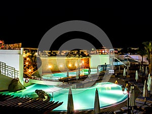 Hotel pool in night.