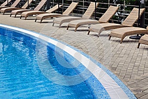 Hotel Poolside Empty Rattan Sunbeds Near Swimming Poll