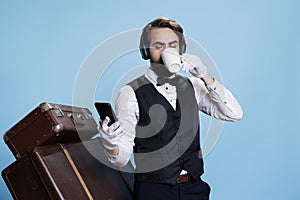Hotel porter drinks coffee and texting