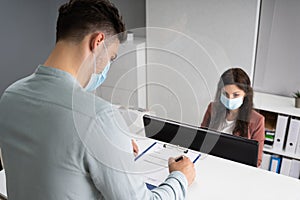 Hotel Reception Desk Protected By Medical Mask