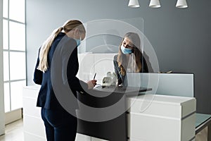 Hotel Reception Desk Protected By Medical Mask