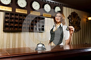 Hotel receptionist and counter desk with bell