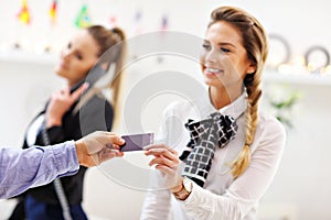 Hotel receptionist giving key card