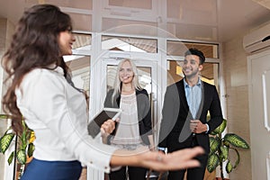 Hotel Receptionist Meeting Business Couple In Lobby, Businesspeople Group Man And Woman Guests Arrive