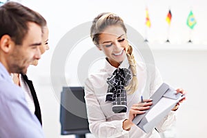 Hotel receptionist talking with guests