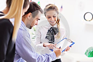 Hotel receptionist talking with guests