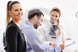 Hotel receptionist talking with guests