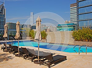 Hotel Rooftop Swimming Pool with deckchair & Buildings