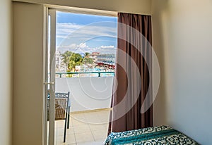 Hotel room with bed and view swimming pool