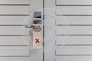 The hotel room with DO NOT DISTURB sign on the door