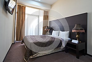 Hotel room interior with double bed furniture. Interior of modern bedroom