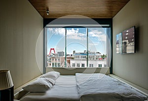 Hotel room with Rotterdam city cityscape skyline with Willemsbrug bridge in window