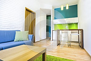 Hotel room with sofa and kitchenette photo