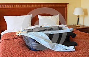 Hotel room with suitcase and clothes