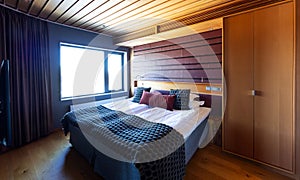 Hotel room with wooden roof and floor.