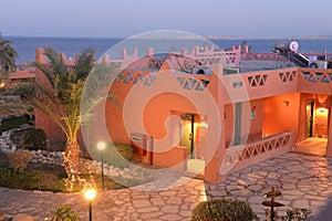 Hotel rooms by the sea at dusk