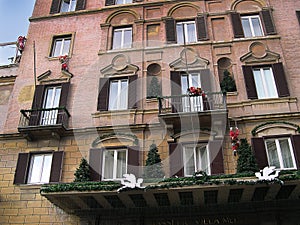 Hotel with Santas climbing up it at the top of the Spanish Steps in Rome Italy photo