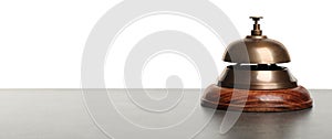 Hotel service bell on grey stone table against background