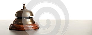 Hotel service bell on grey stone table against background