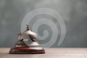 Hotel service bell on table. Space for text