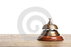 Hotel service bell on wooden table against background