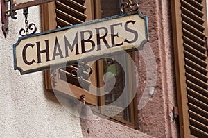 hotel signage on stoned wall with french text Chambre