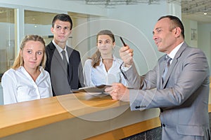 Hotel staff following supervisor`s gaze