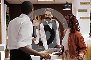 Hotel staff welcoming guests at counter